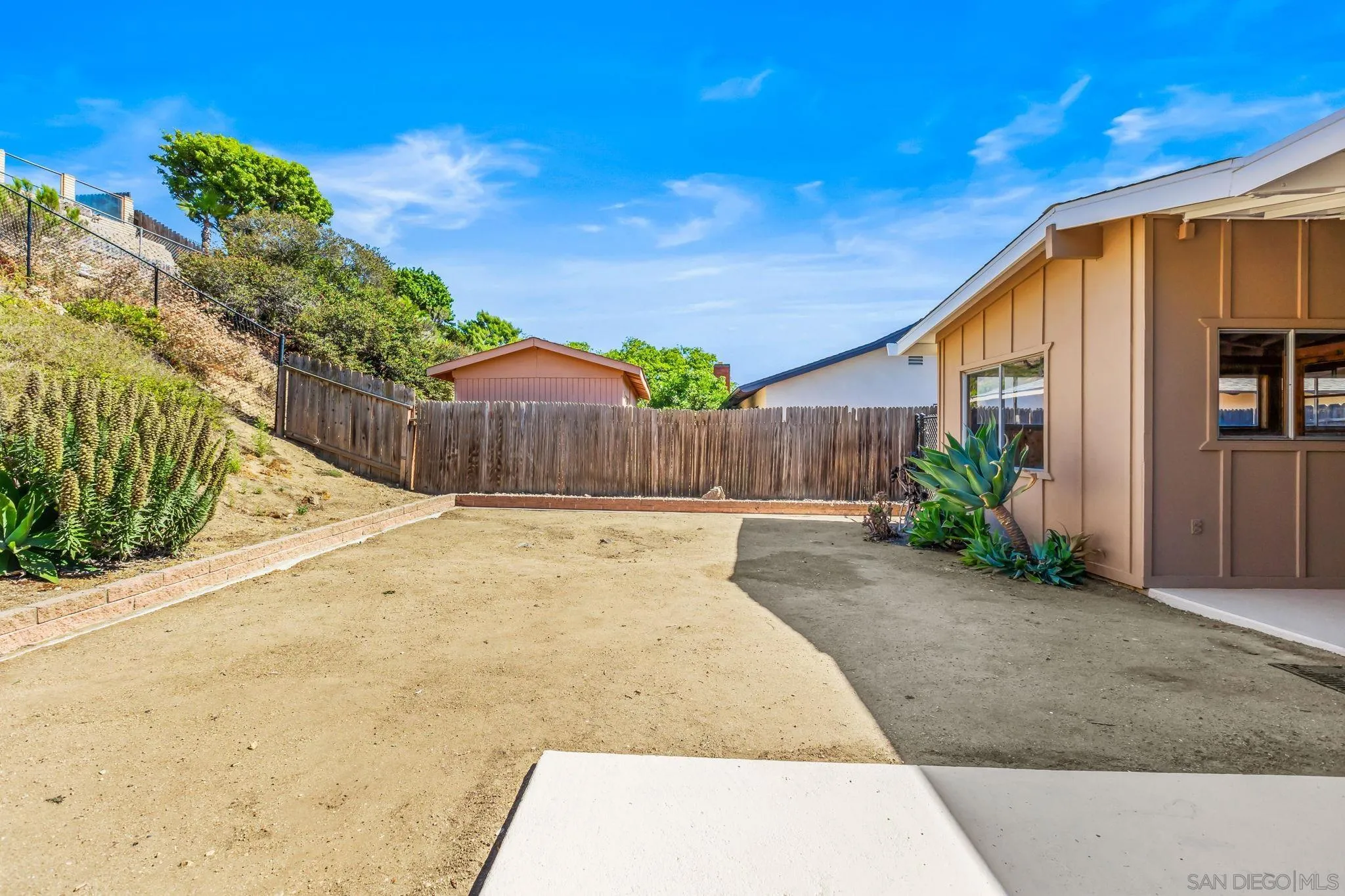 13323 Frame Road Poway, CA 92064 - Photo 24 of 30 a view of a backyard with potted plants and wooden fence