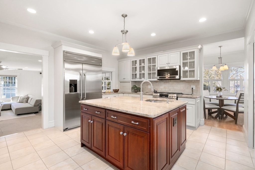 40 Hillcrest Road Belmont, MA 02478 - Photo 11 of 39 a kitchen with kitchen island granite countertop a stove oven and a refrigerator with white cabinets