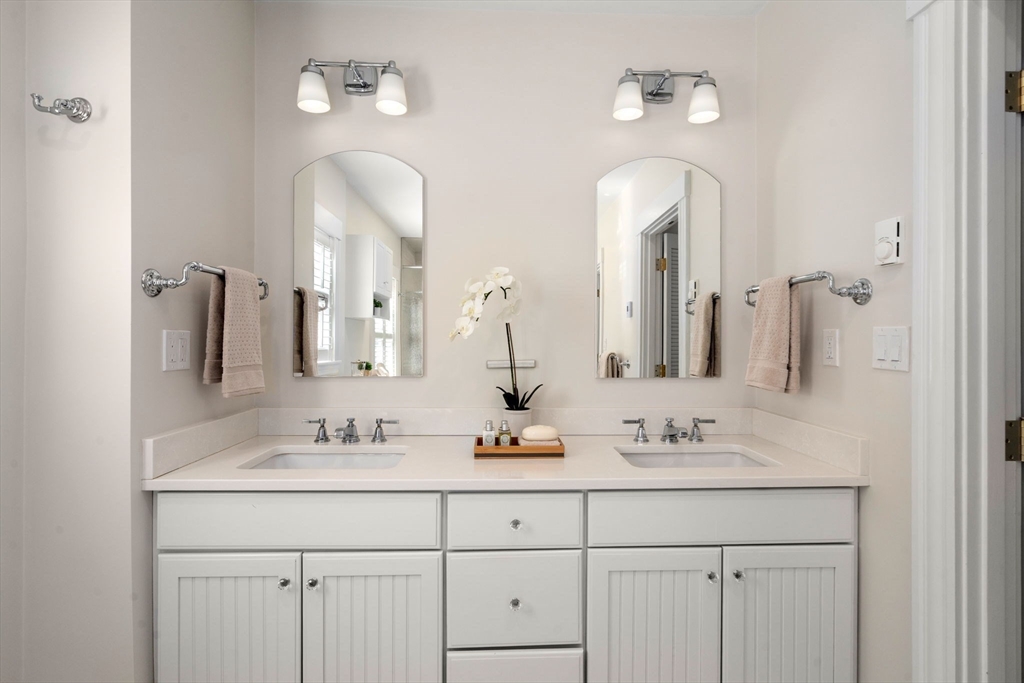 40 Hillcrest Road Belmont, MA 02478 - Photo 22 of 39 a bathroom with double vanity sinks and a mirror