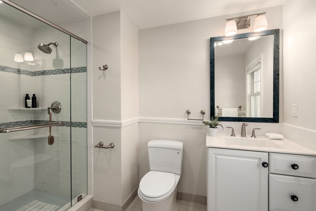 40 Hillcrest Road Belmont, MA 02478 - Photo 26 of 39 a bathroom with a toilet sink vanity and mirror