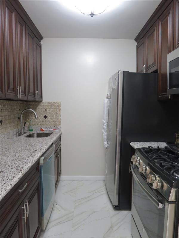 630 1st Avenue, Unit 16K Manhattan, NY 10016 - Photo 1 of 1 a kitchen with stainless steel appliances granite countertop a refrigerator stove and sink