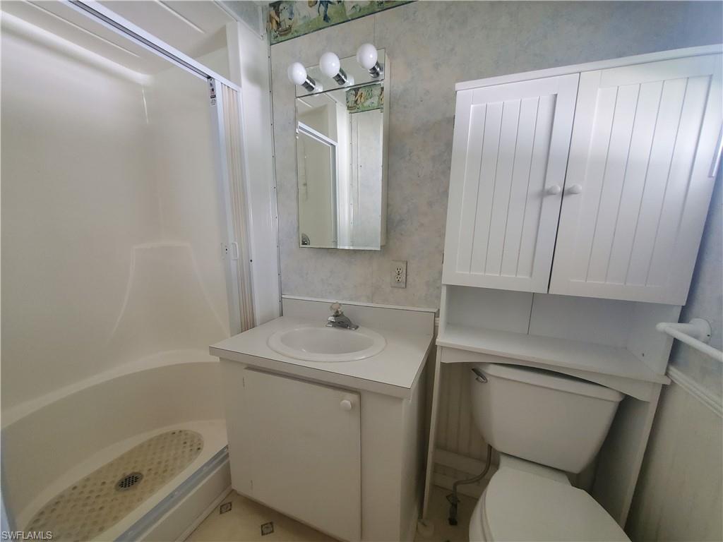 40 Enchanting Boulevard, Unit E40 Naples, FL 34112 - Photo 6 of 9 a bathroom with a sink a toilet and shower