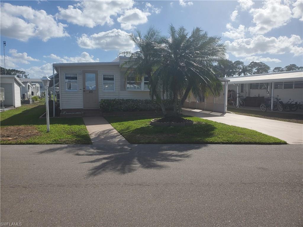 40 Enchanting Boulevard, Unit E40 Naples, FL 34112 - Photo 9 of 9 a view of a house with a yard