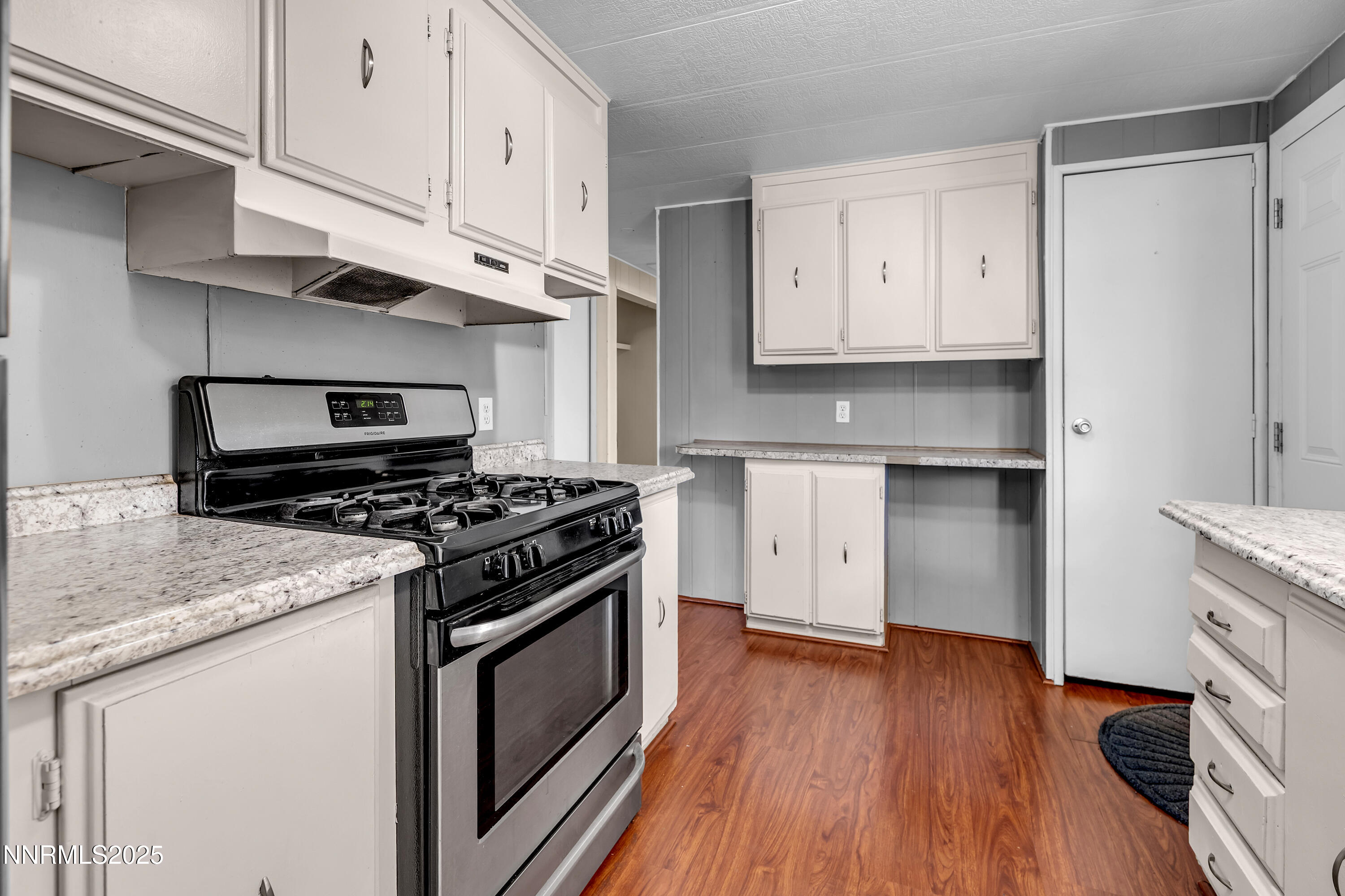 5760 Leon Drive Sun Valley, NV 89433 - Photo 12 of 42 a kitchen with a stove oven and white cabinets