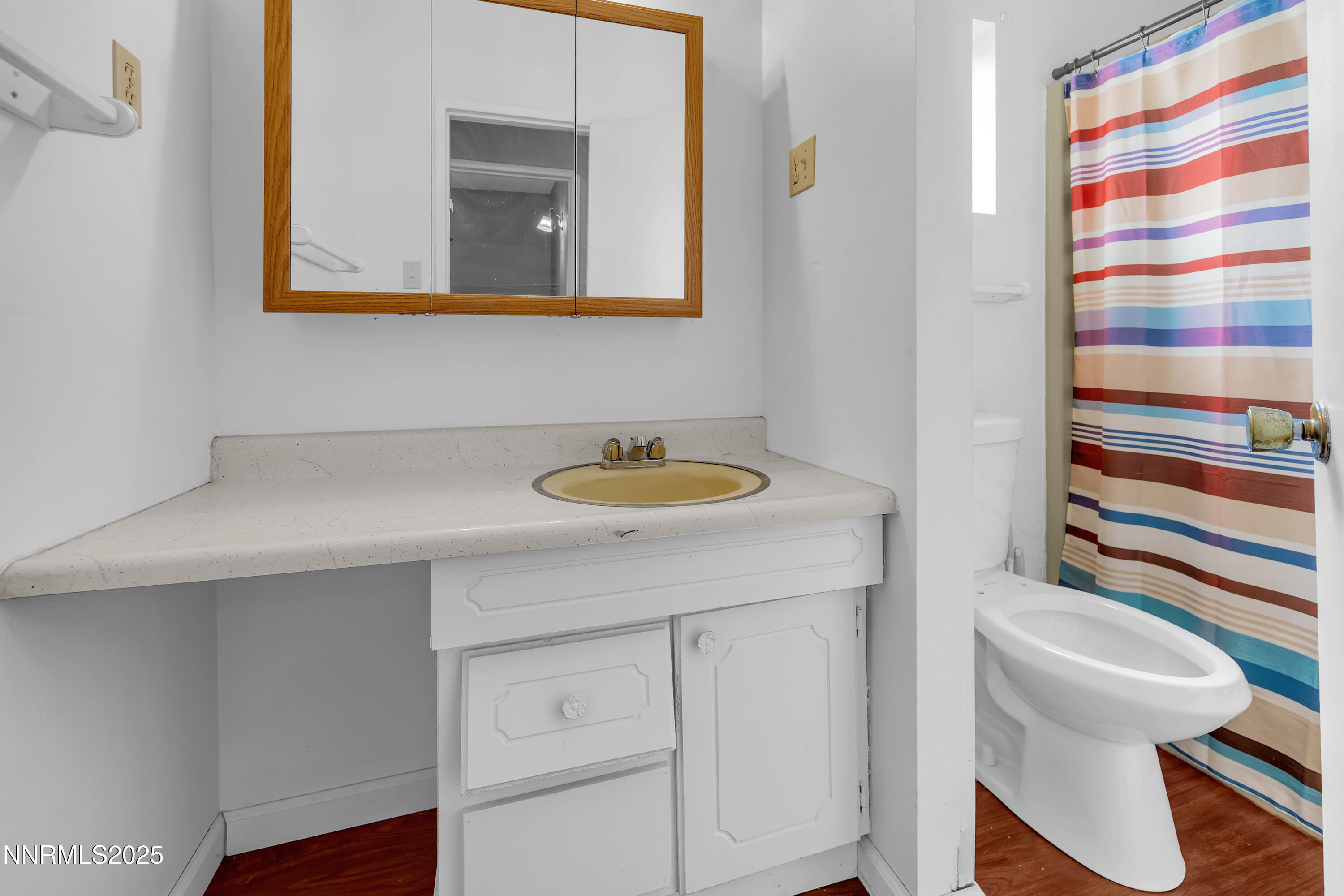 5760 Leon Drive Sun Valley, NV 89433 - Photo 20 of 42 a bathroom with a sink a toilet and a mirror