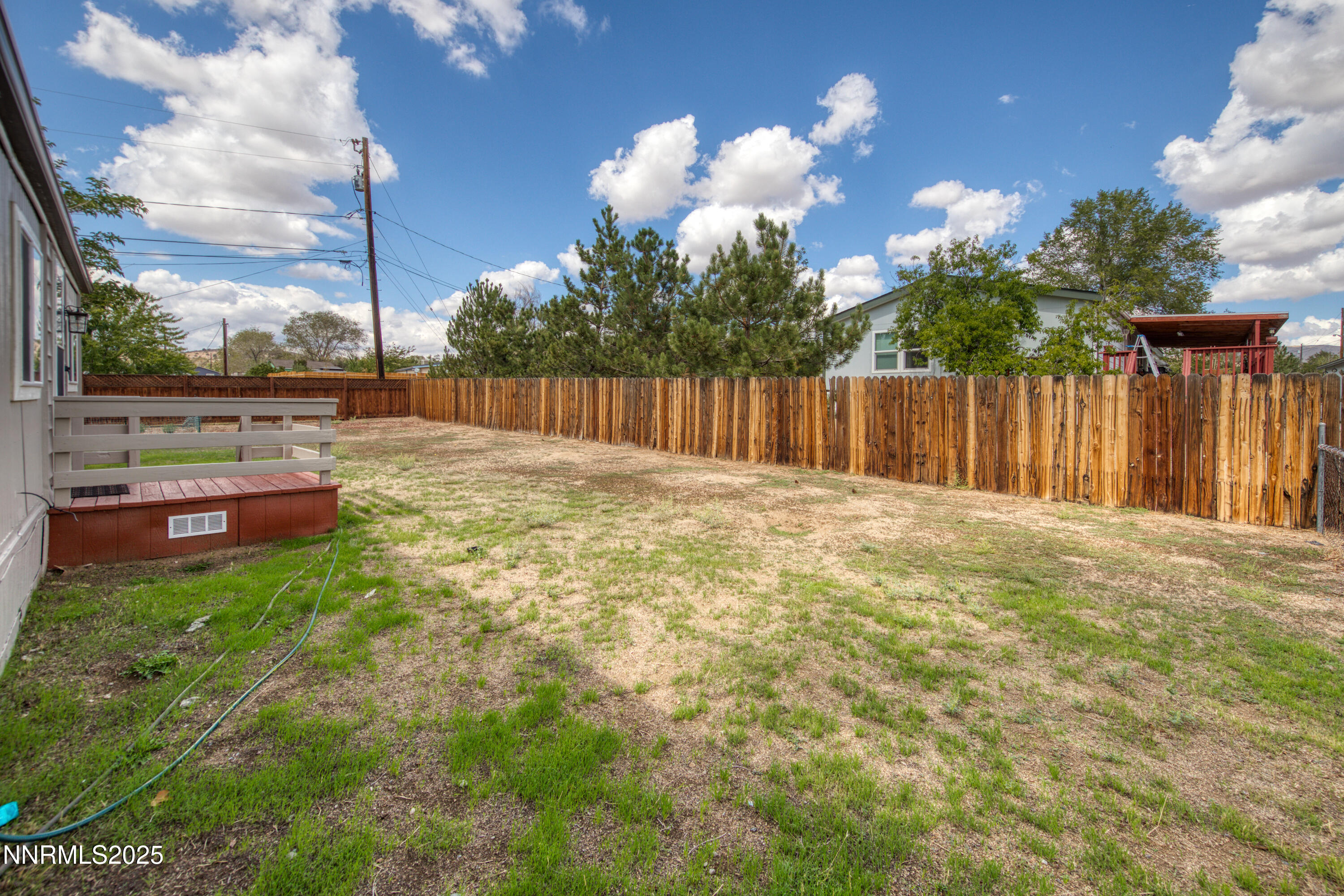 5760 Leon Drive Sun Valley, NV 89433 - Photo 35 of 42 a view of backyard with seating space and trees