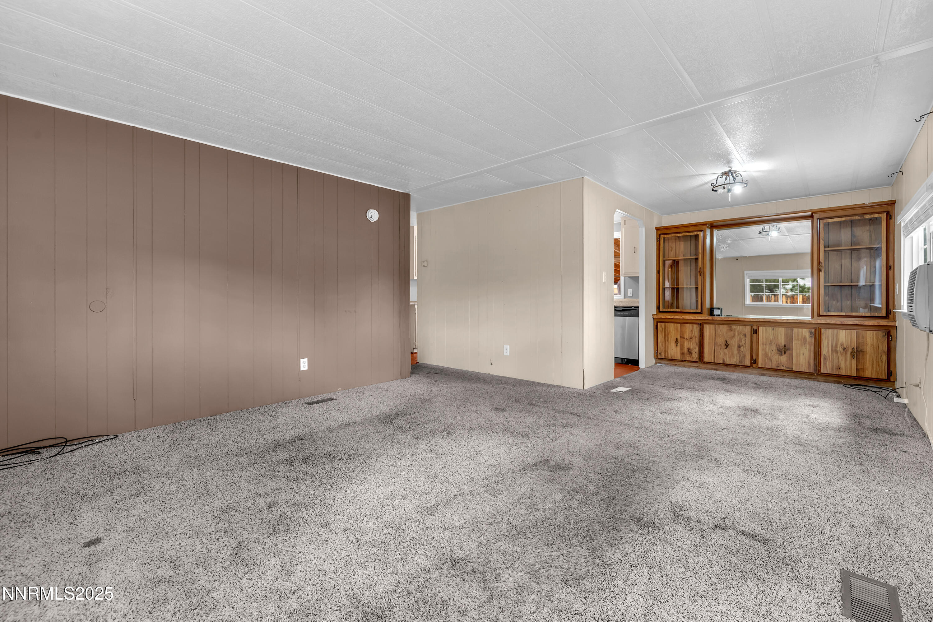 5760 Leon Drive Sun Valley, NV 89433 - Photo 6 of 42 a view of an empty room with a kitchen