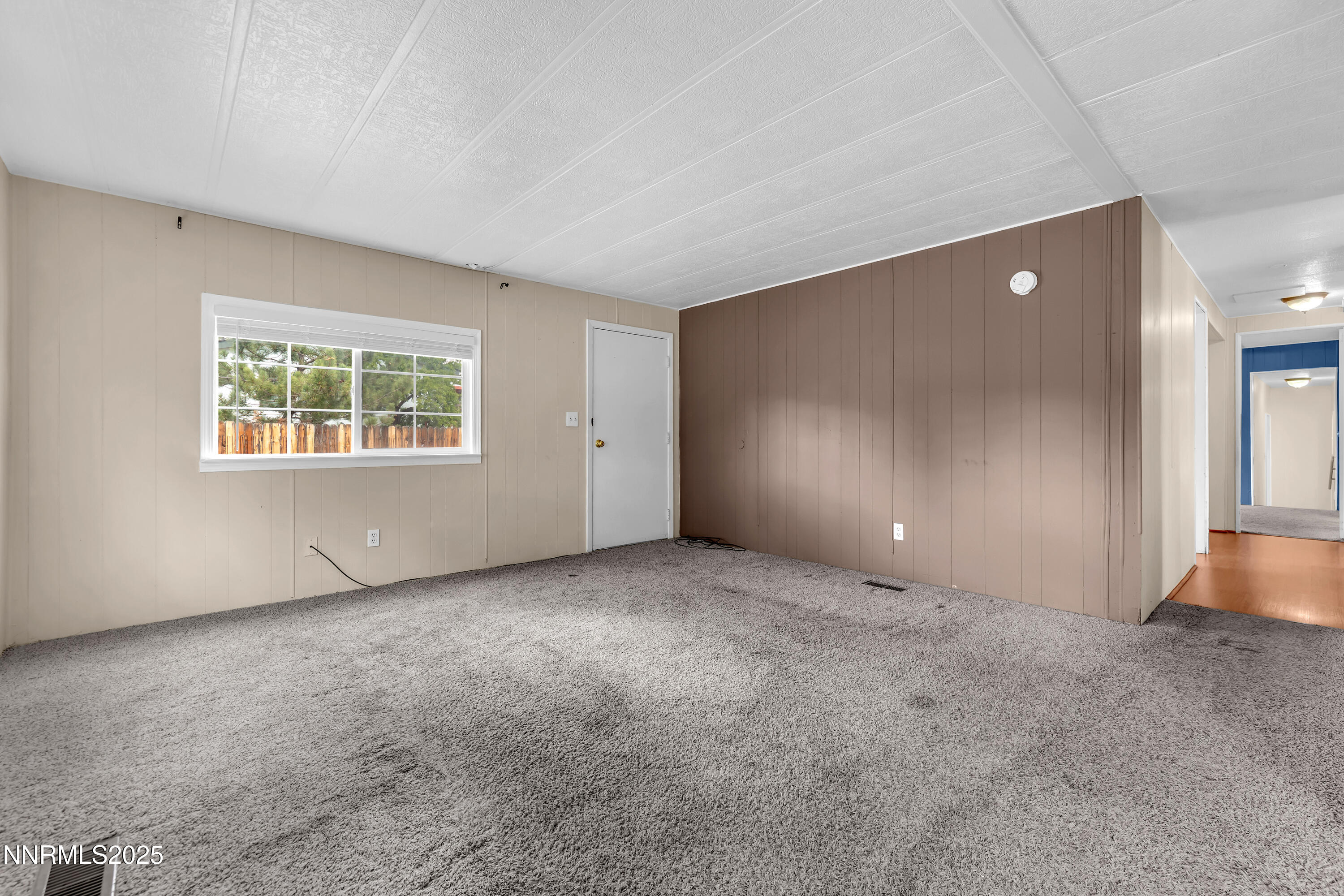 5760 Leon Drive Sun Valley, NV 89433 - Photo 7 of 42 an empty room with windows and closet