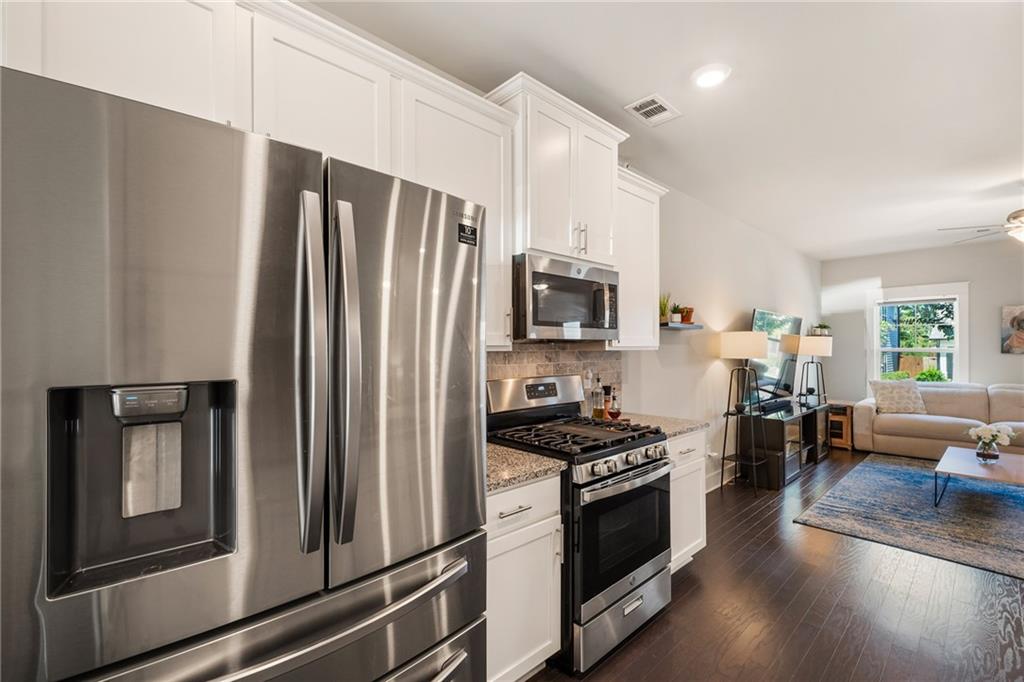 278 Perry Point Run, Unit 56 Lawrenceville, GA 30046 - Photo 12 of 36 a kitchen with stainless steel appliances a refrigerator stove and microwave