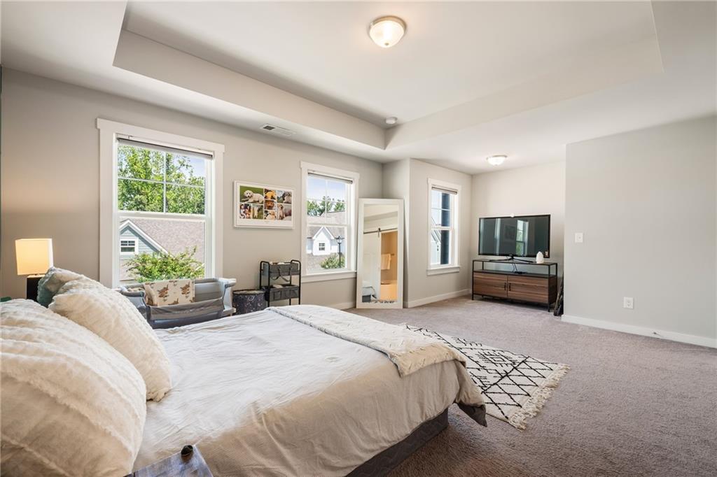 278 Perry Point Run, Unit 56 Lawrenceville, GA 30046 - Photo 16 of 36 a bedroom with a bed a couch and a window