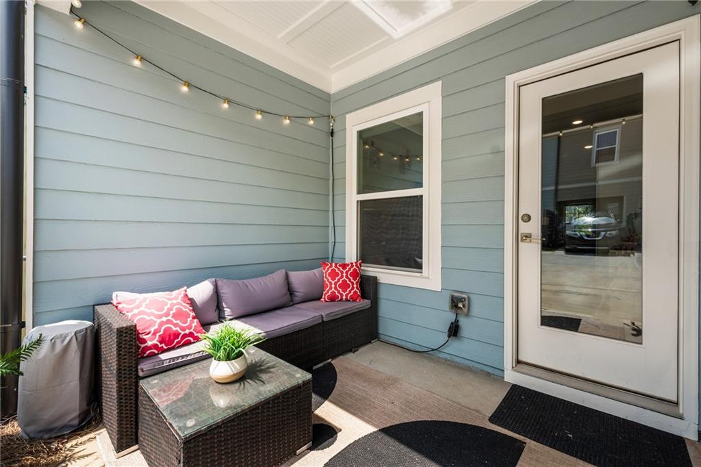 278 Perry Point Run, Unit 56 Lawrenceville, GA 30046 - Photo 2 of 36 a outdoor living space with furniture and a potted plant