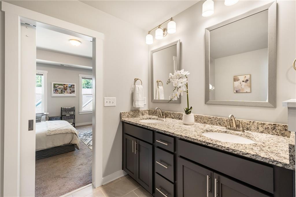 278 Perry Point Run, Unit 56 Lawrenceville, GA 30046 - Photo 21 of 36 a en suite bathroom with a granite countertop sink and a mirror