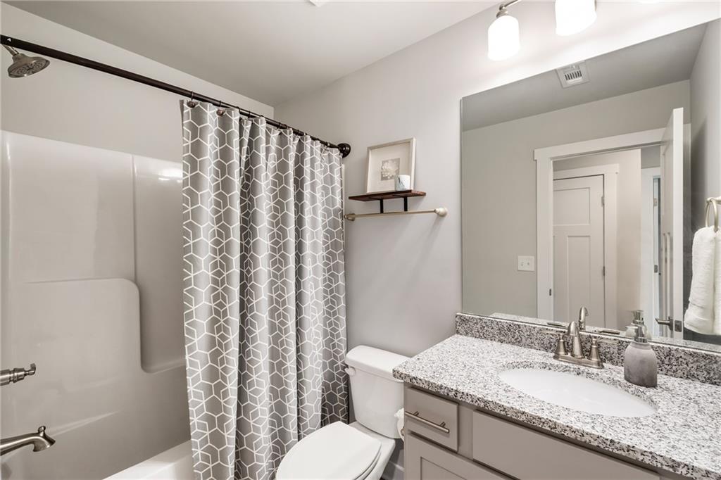 278 Perry Point Run, Unit 56 Lawrenceville, GA 30046 - Photo 24 of 36 a bathroom with a granite countertop sink toilet and shower