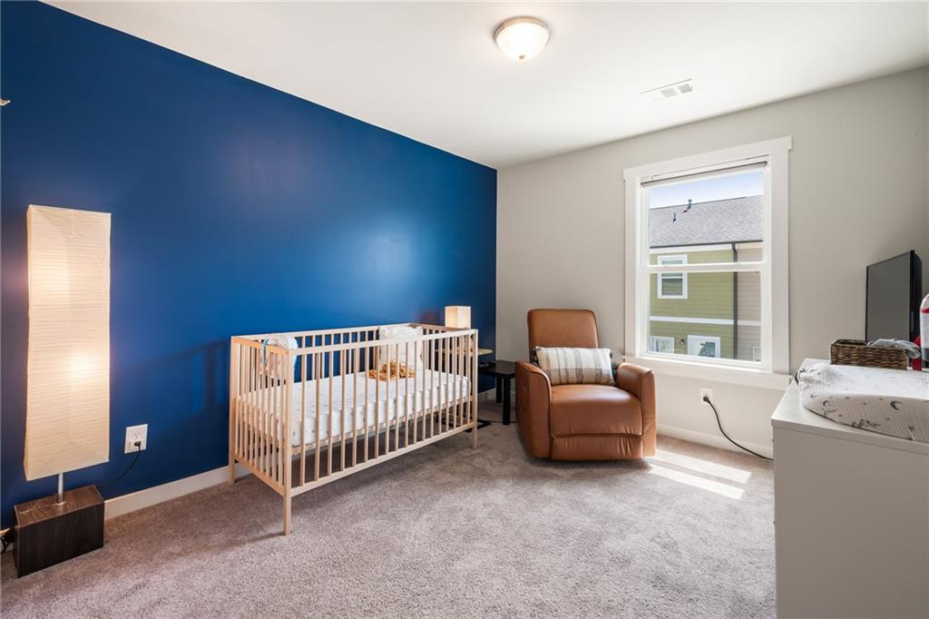 278 Perry Point Run, Unit 56 Lawrenceville, GA 30046 - Photo 25 of 36 a bedroom with furniture and a window
