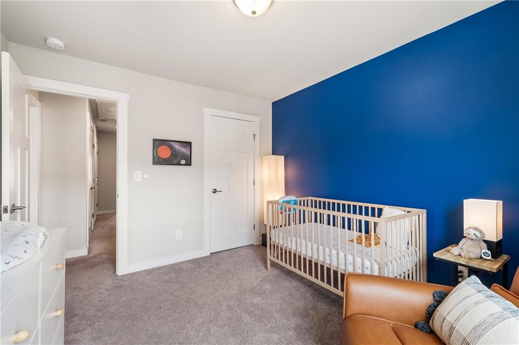 278 Perry Point Run, Unit 56 Lawrenceville, GA 30046 - Photo 26 of 36 a bedroom with furniture and wooden floor