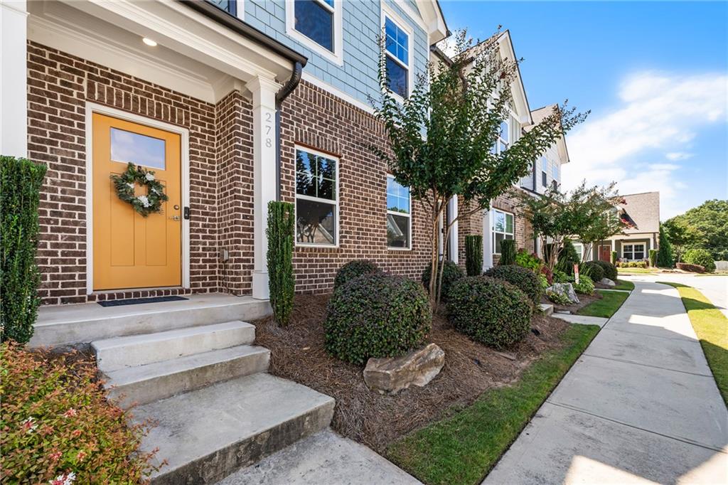 278 Perry Point Run, Unit 56 Lawrenceville, GA 30046 - Photo 31 of 36 a front view of a house with garden