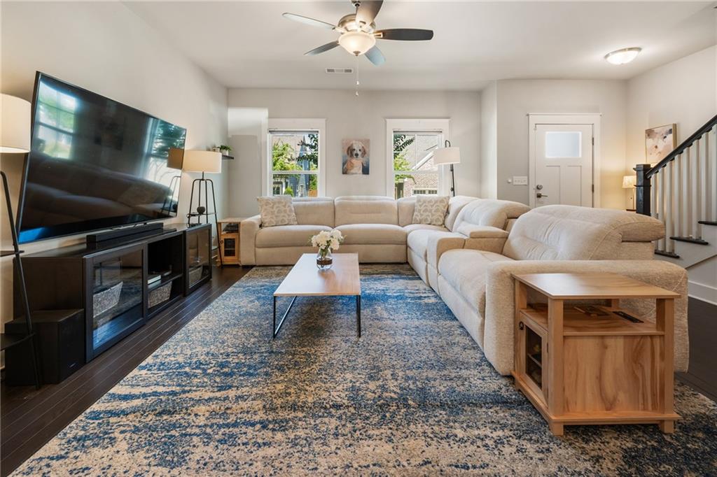 278 Perry Point Run, Unit 56 Lawrenceville, GA 30046 - Photo 7 of 36 a living room with furniture and a flat screen tv