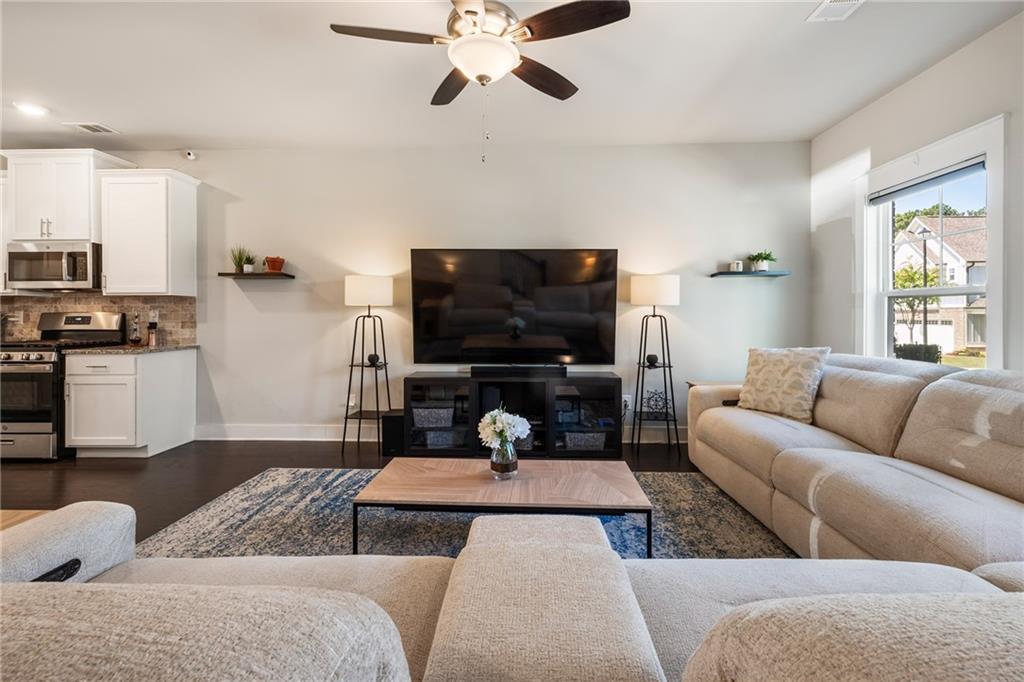 278 Perry Point Run, Unit 56 Lawrenceville, GA 30046 - Photo 8 of 36 a living room with furniture and a flat screen tv