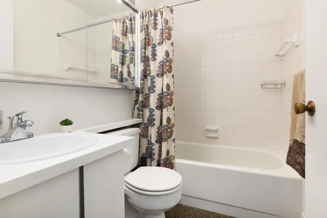 a kitchen with stainless steel appliances granite countertop a refrigerator a sink and white cabinets