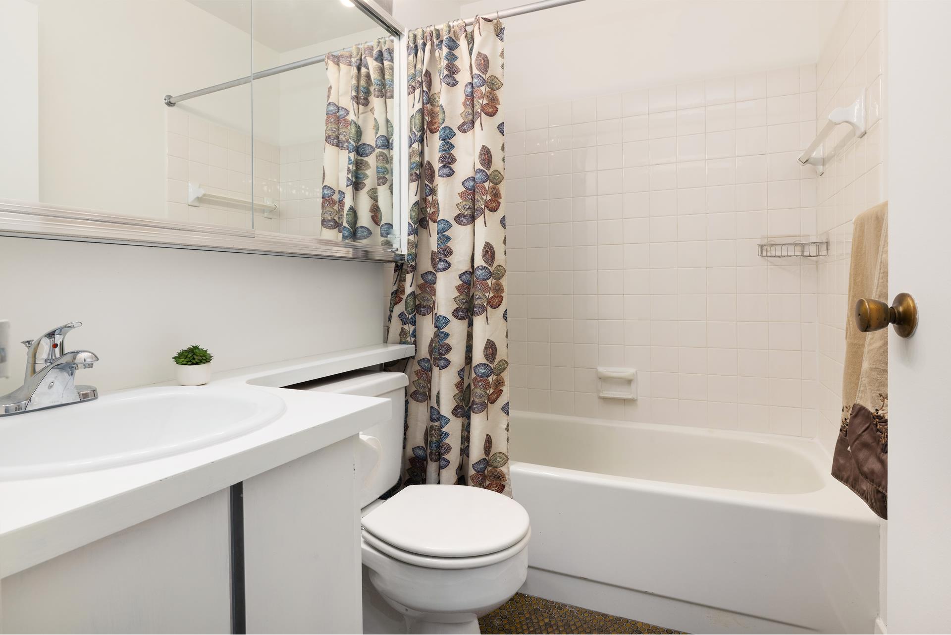 244 Madison Avenue, Unit 12F Manhattan, NY 10016 - Photo 5 of 11 a bathroom with a sink a toilet and bathtub