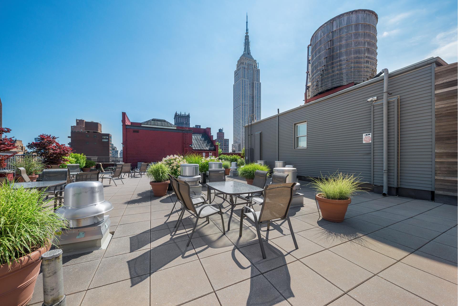 244 Madison Avenue, Unit 12F Manhattan, NY 10016 - Photo 7 of 11 a view of a patio with plants and chairs