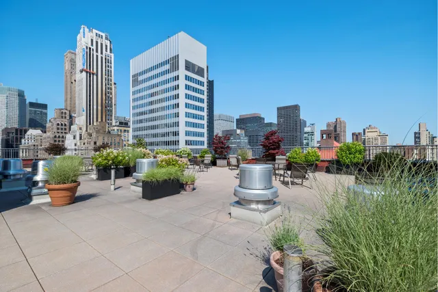 a view of outdoor dining space with a table and chairs