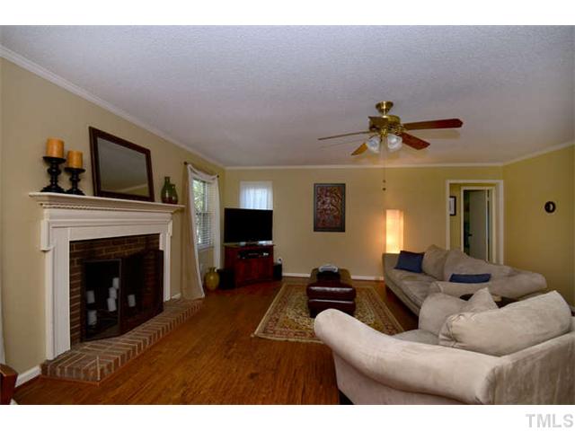 7309 Mine Valley Road Raleigh, NC 27615 - Photo 3 of 15 a living room with furniture and a fireplace