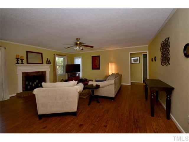 7309 Mine Valley Road Raleigh, NC 27615 - Photo 4 of 15 a living room with furniture and a fireplace