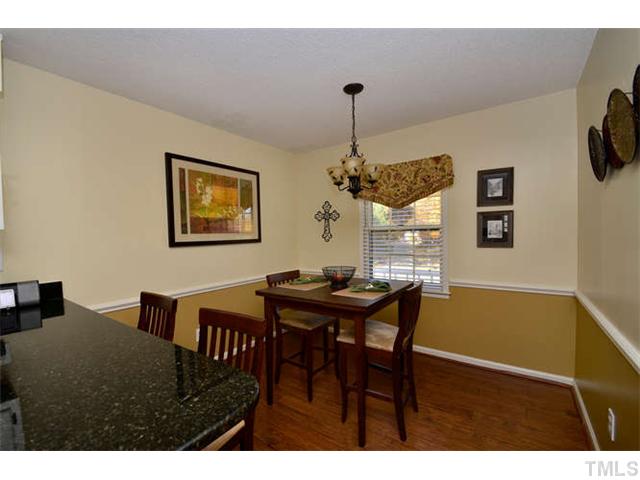 7309 Mine Valley Road Raleigh, NC 27615 - Photo 7 of 15 a view of a dining room with furniture and wooden floor
