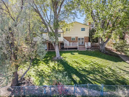 a view of a house with a yard and sitting area