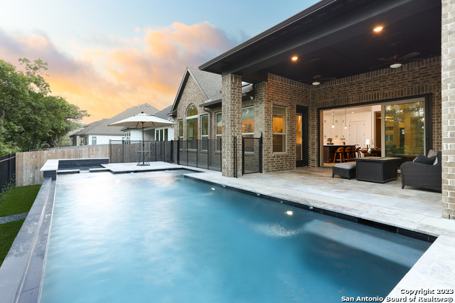 a view of swimming pool with seating space