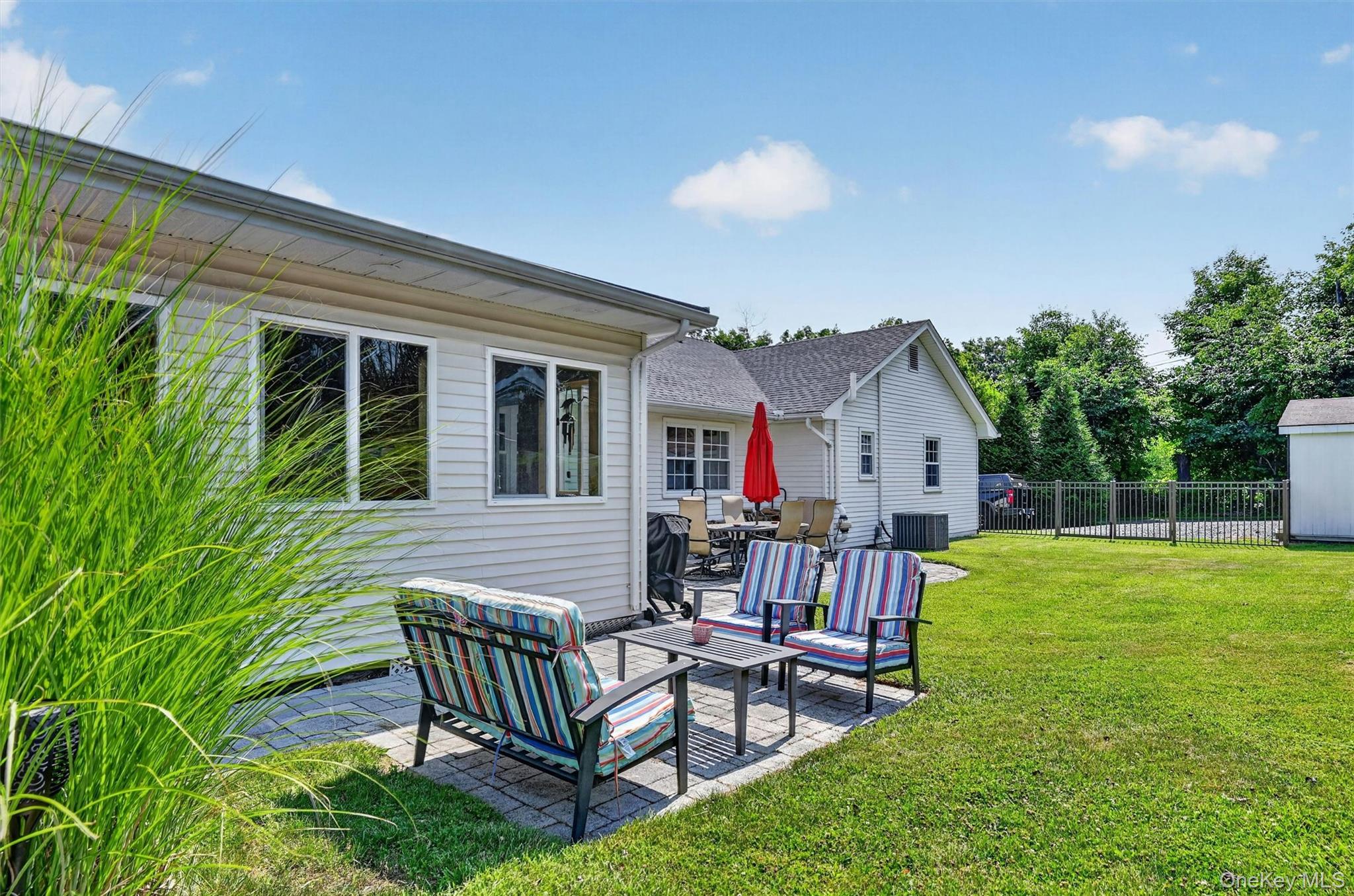 5 Hedges Road Warwick, NY 10990 - Photo 40 of 48 The backyard offers multiple patio areas for dining, lounging, and entertaining, giving everyone a place to gather or unwind.