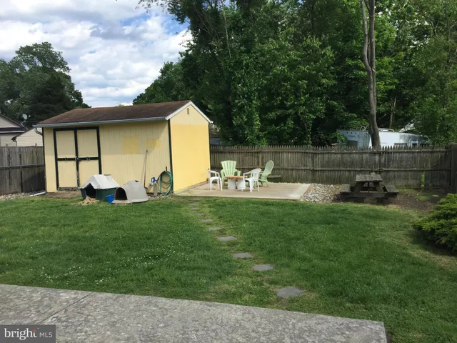 a view of a backyard with sitting area
