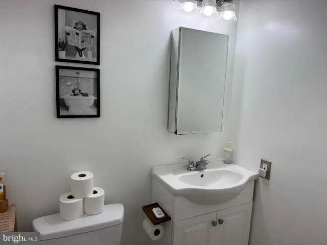 a bathroom with a sink toilet and a mirror