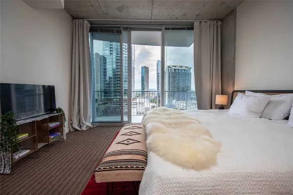 a bedroom with a bed and flat screen tv