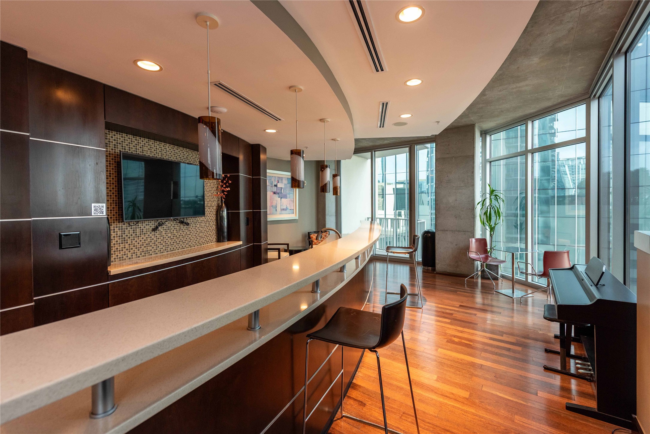 360 Nueces Street, Unit 1214 Austin, TX 78701 - Photo 29 of 38 Community bar area featuring expansive windows, modern cabinets, decorative light fixtures, dark brown cabinetry, and recessed lighting
