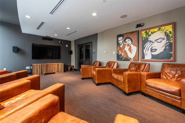 a view of a workspace with furniture and a flat screen tv