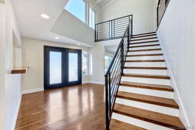 a view of entryway and hall with wooden floor