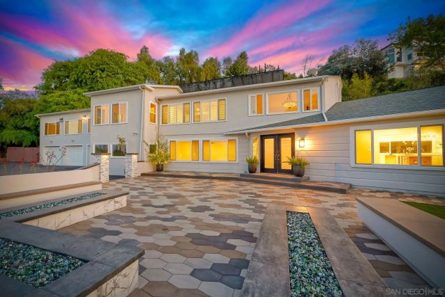 an aerial view of a house with swimming pool and a yard