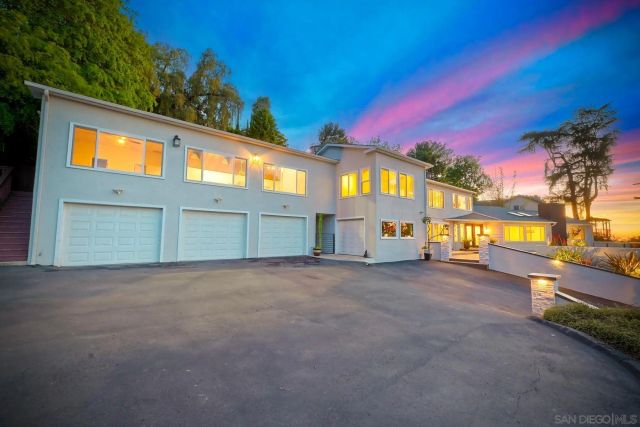 an aerial view of a house with a garden and trees