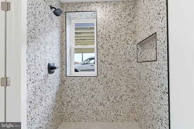 a bathroom with a shower and a sink