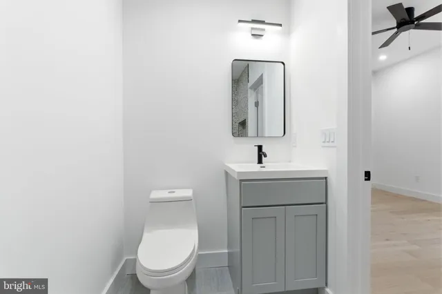 a bathroom with a toilet a sink and mirror