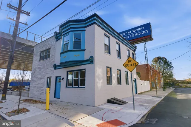 a view of a white house with large windows