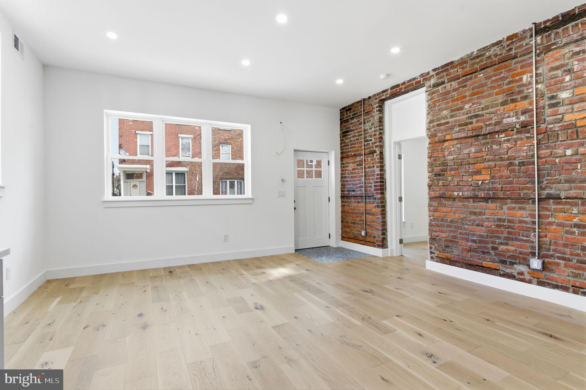 2724-26 East Somerset Street, Unit 1 Philadelphia, PA 19134 - Photo 4 of 21 a view of an empty room with wooden floor and a window