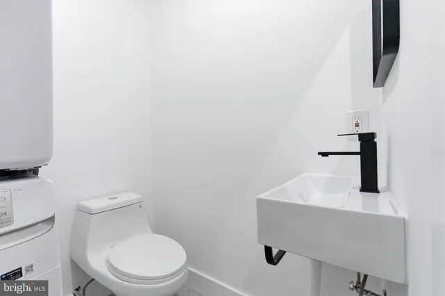 a white toilet sitting next to a bathroom sink