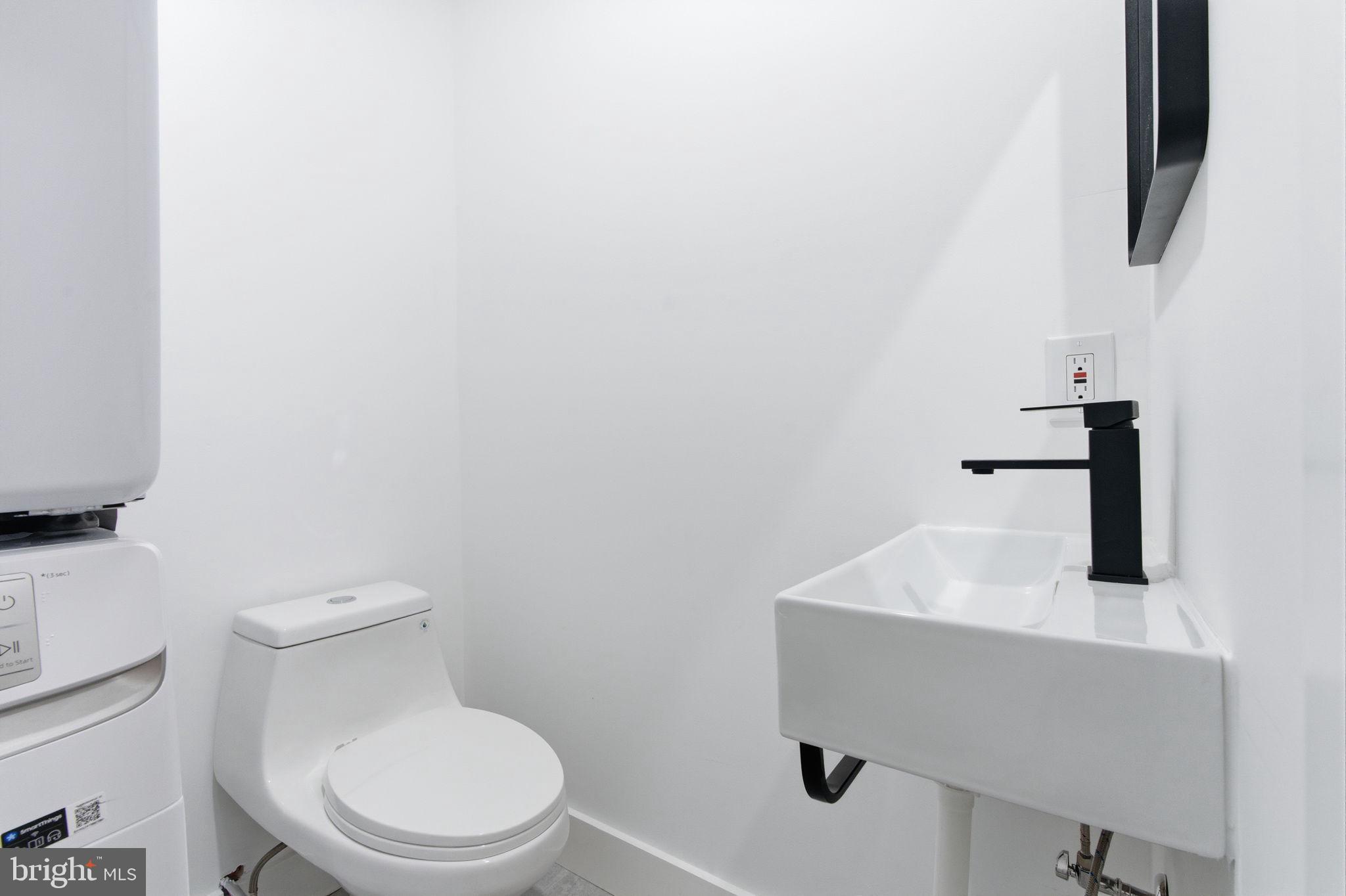 2724-26 East Somerset Street, Unit 1 Philadelphia, PA 19134 - Photo 8 of 21 a white toilet sitting next to a bathroom sink