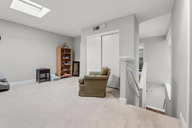 a bedroom with a bed and a flat tv screen on the dresser