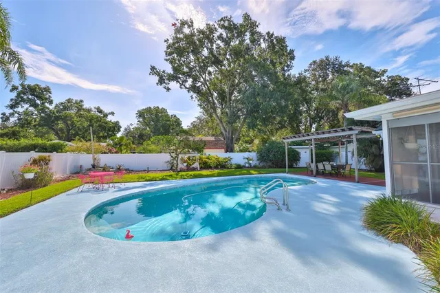 a view of a swimming pool with an outdoor seating