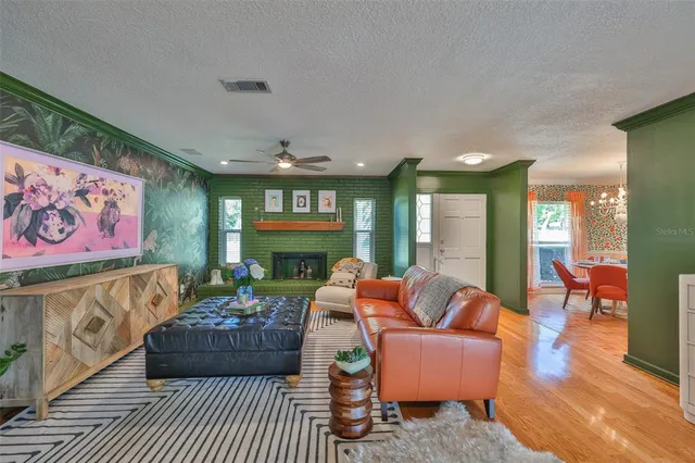 a spacious bedroom with a large bed and a chandelier