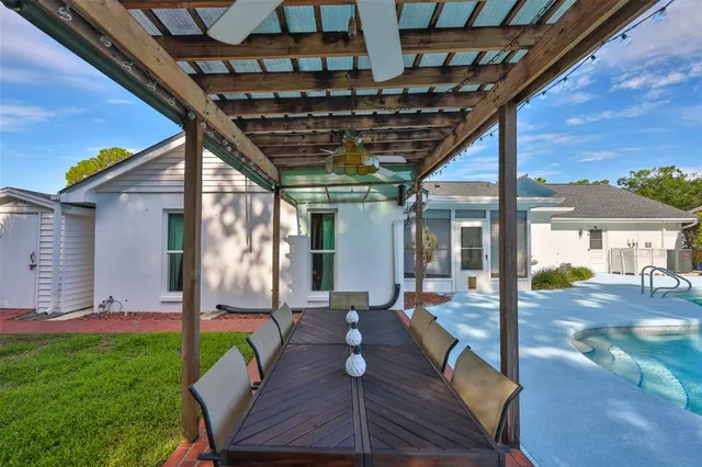 an aerial view of a house with garden space ocean and trees